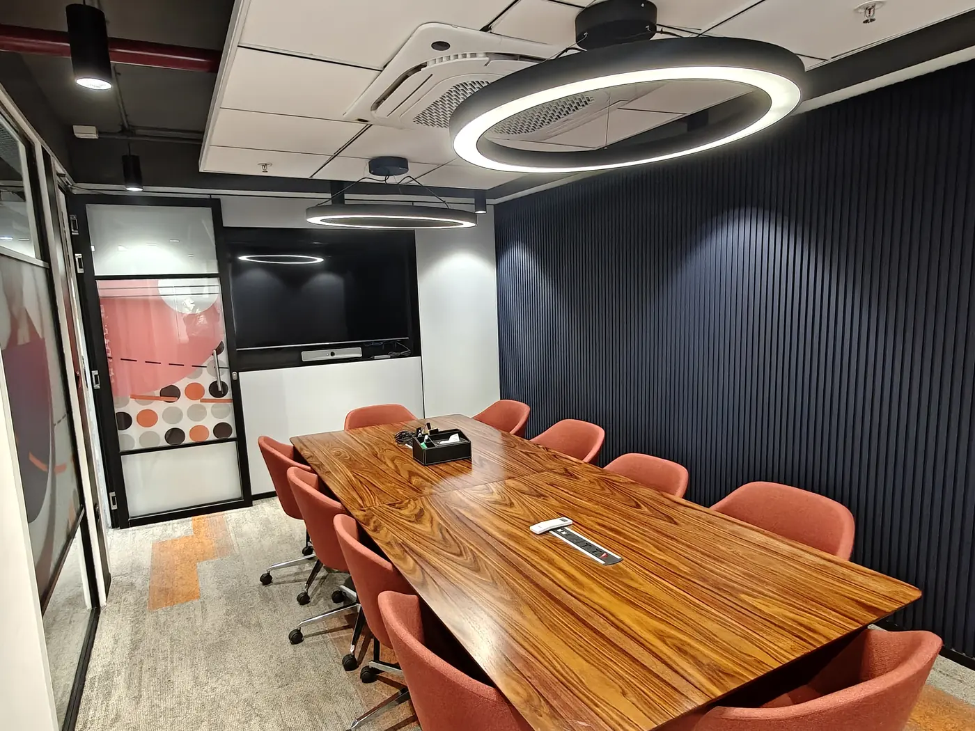 The conference room in Bengaluru, with a long table and a screen at the far end.