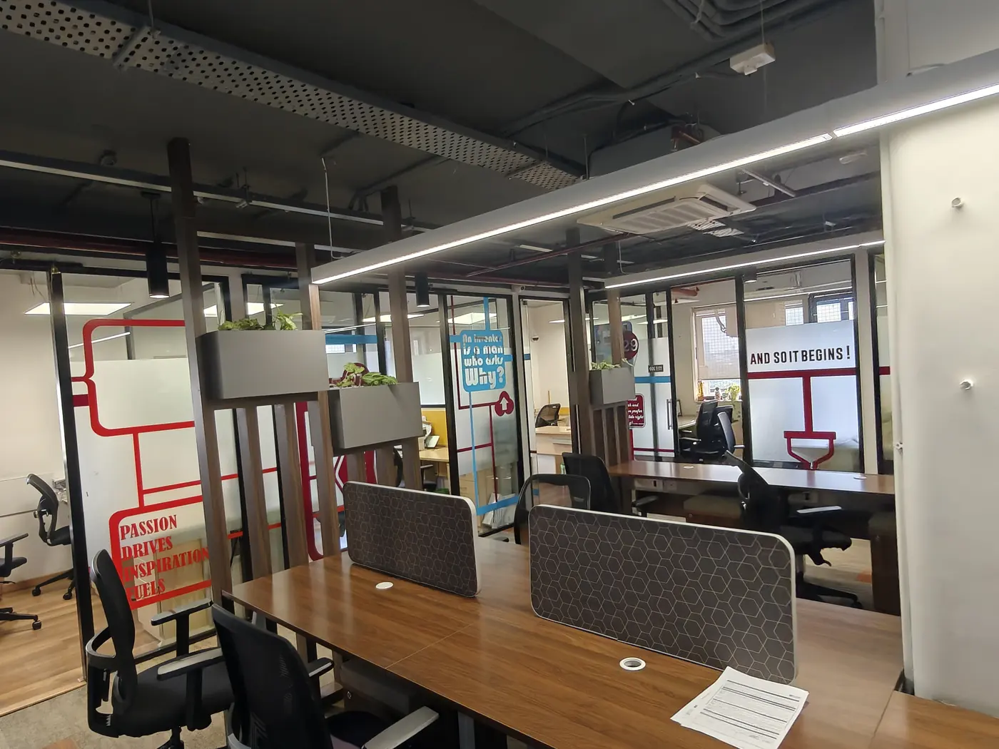 Work desks behind glass partitions in the Bengaluru office.