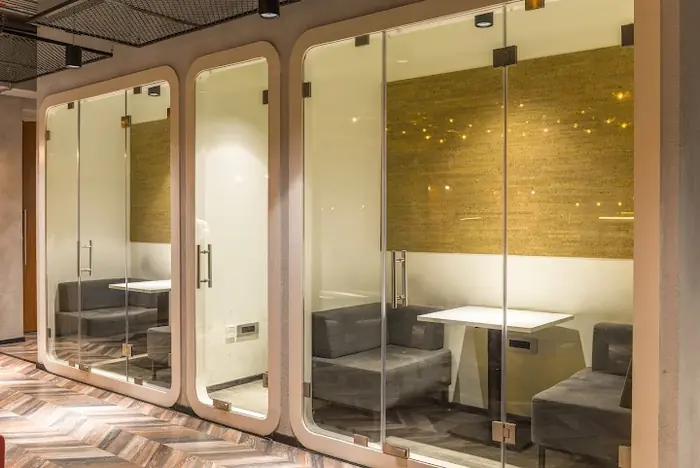 Glass meeting rooms in the Mumbai office at Bandra Kurla Complex.