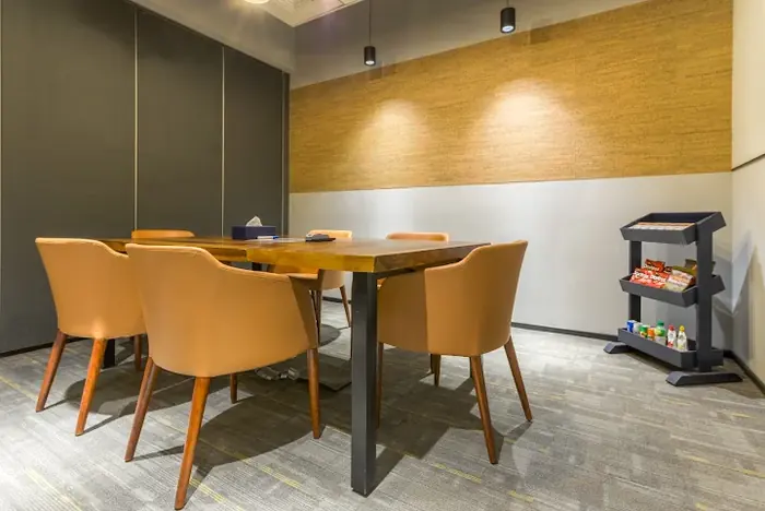 A meeting room in Mumbai, with a wooden table and six chairs.